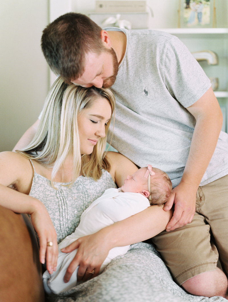 mother and father adoring newborn