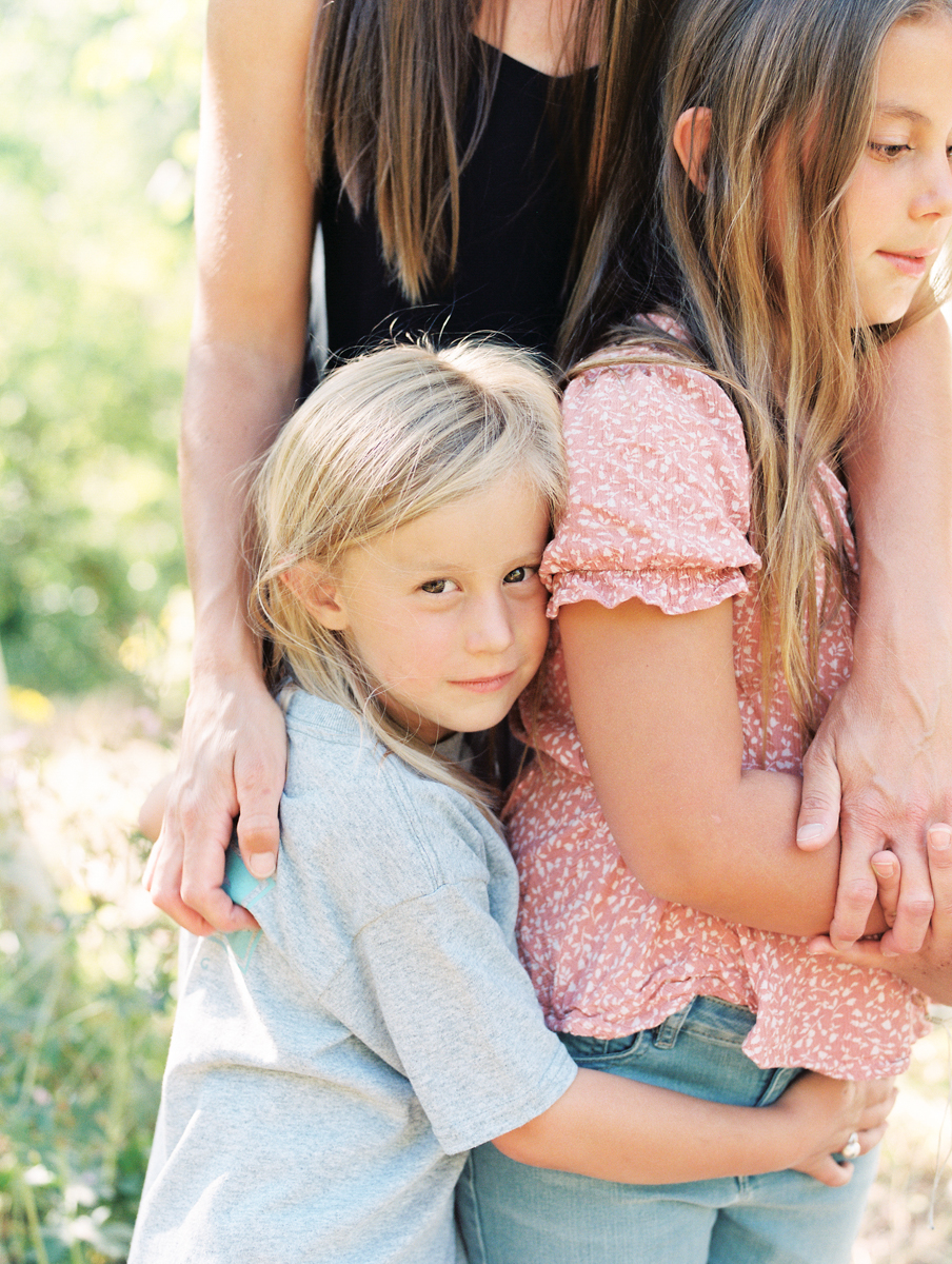 close up portrait of boy next to sister