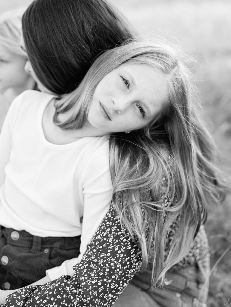 young girl laying on mother