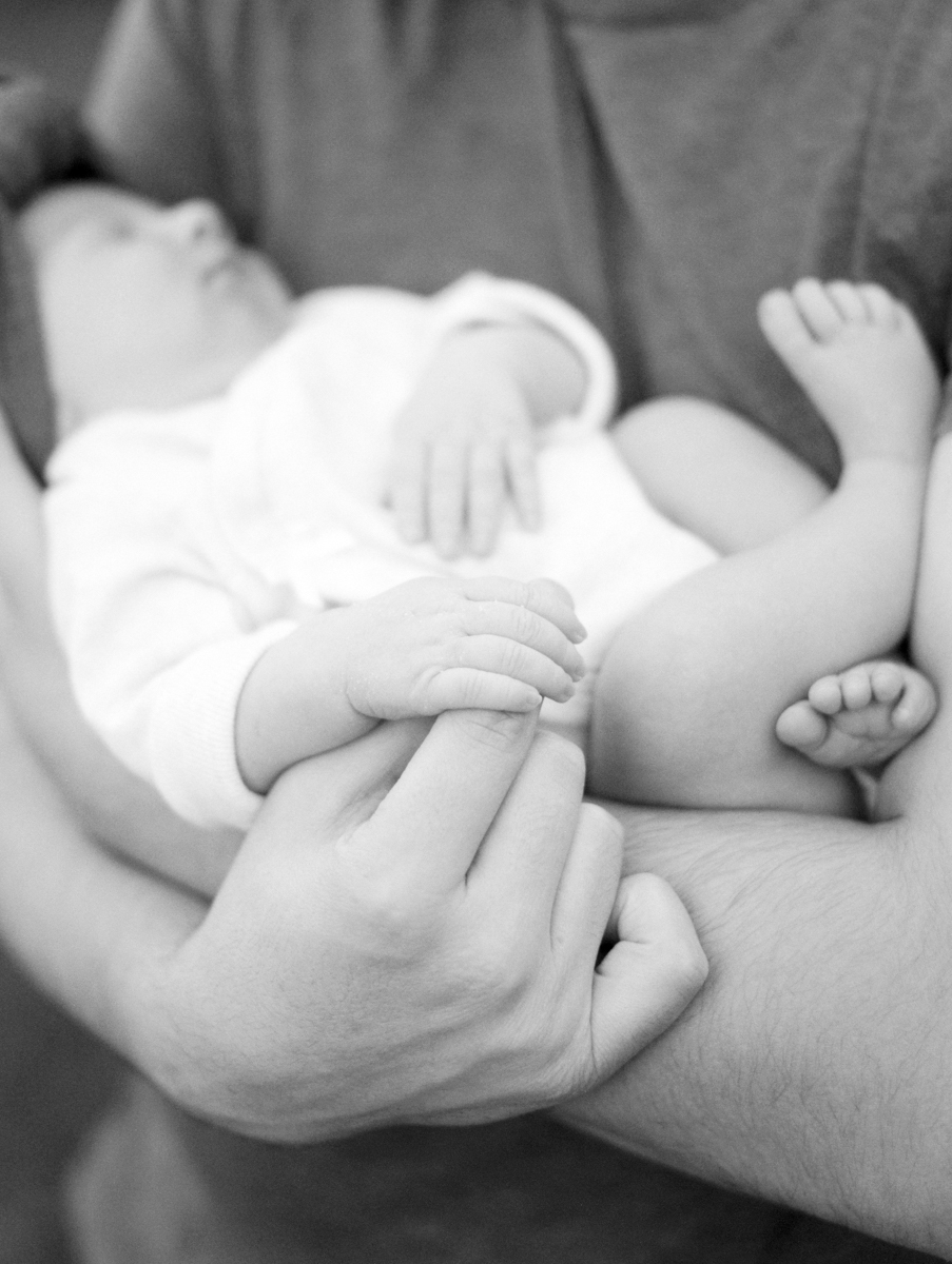close up of father holding newborn baby