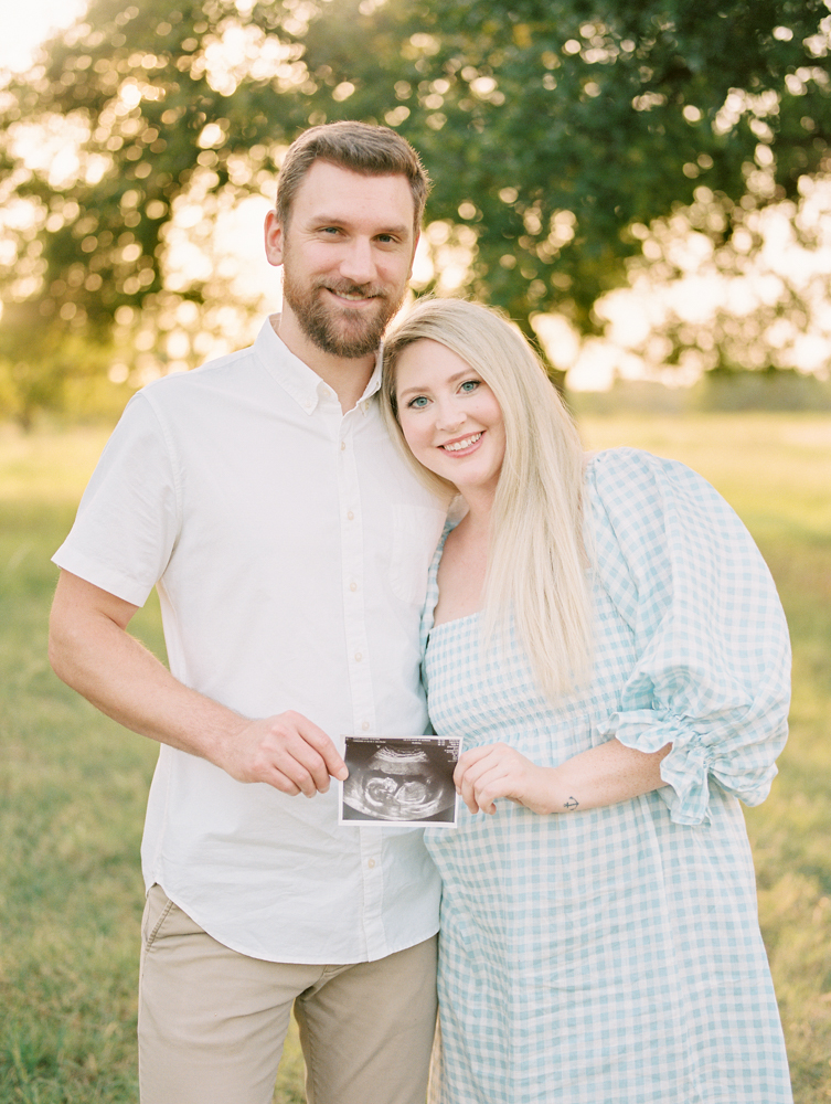 couple holding ultrasound photo