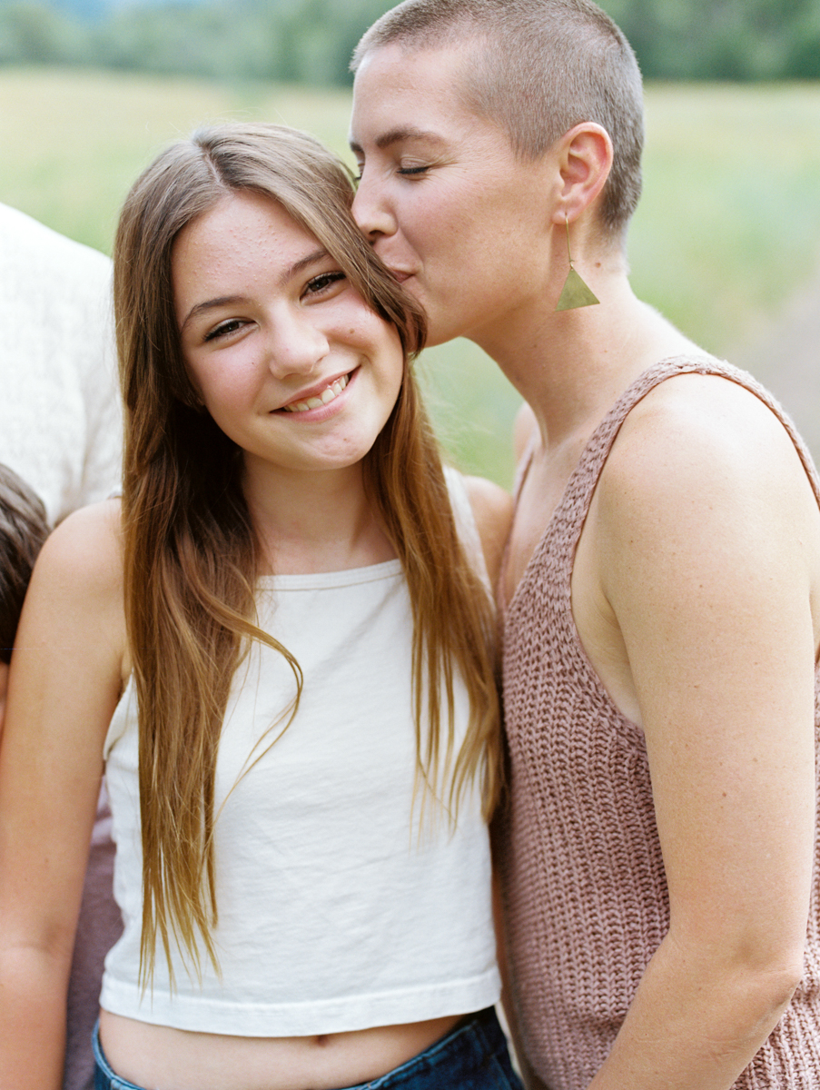 mom kissing daughter's head