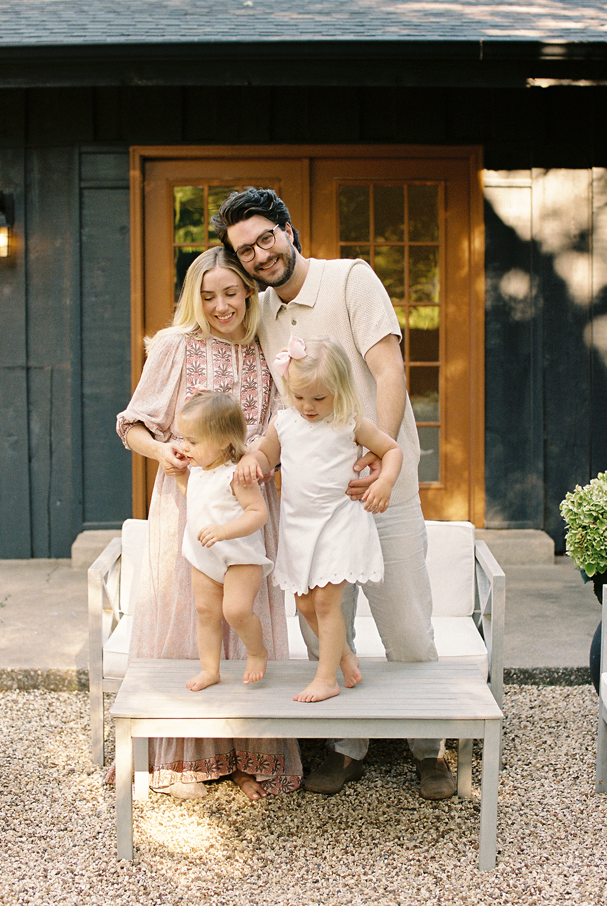 a mother, father, and two young daughters, in their backyard at their home in oklahoma city