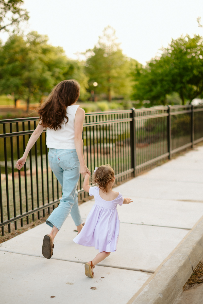 mother holding and running with her young daughter during a photo session in Oklahoma City