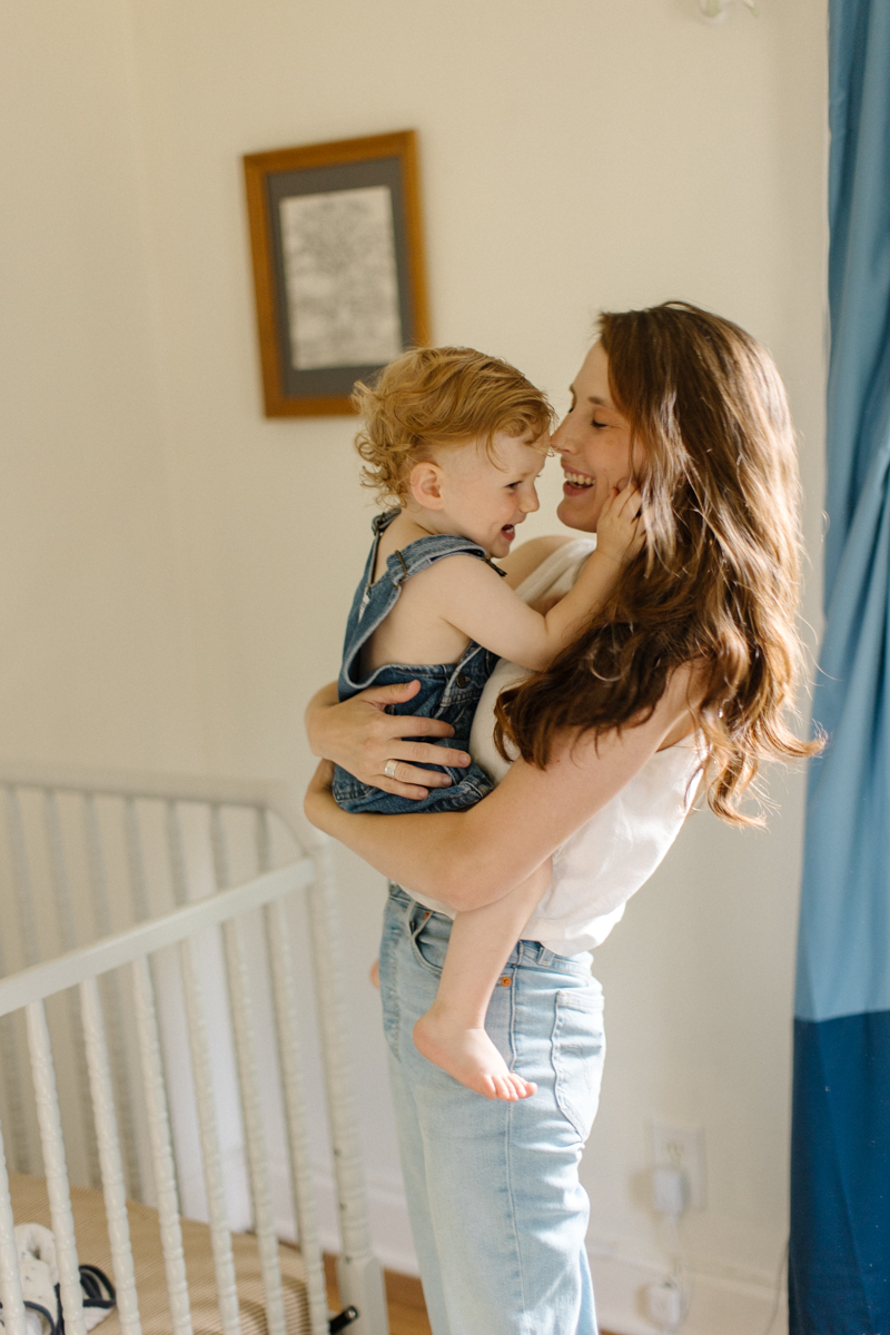 other holding son in nursery, both of them smiling