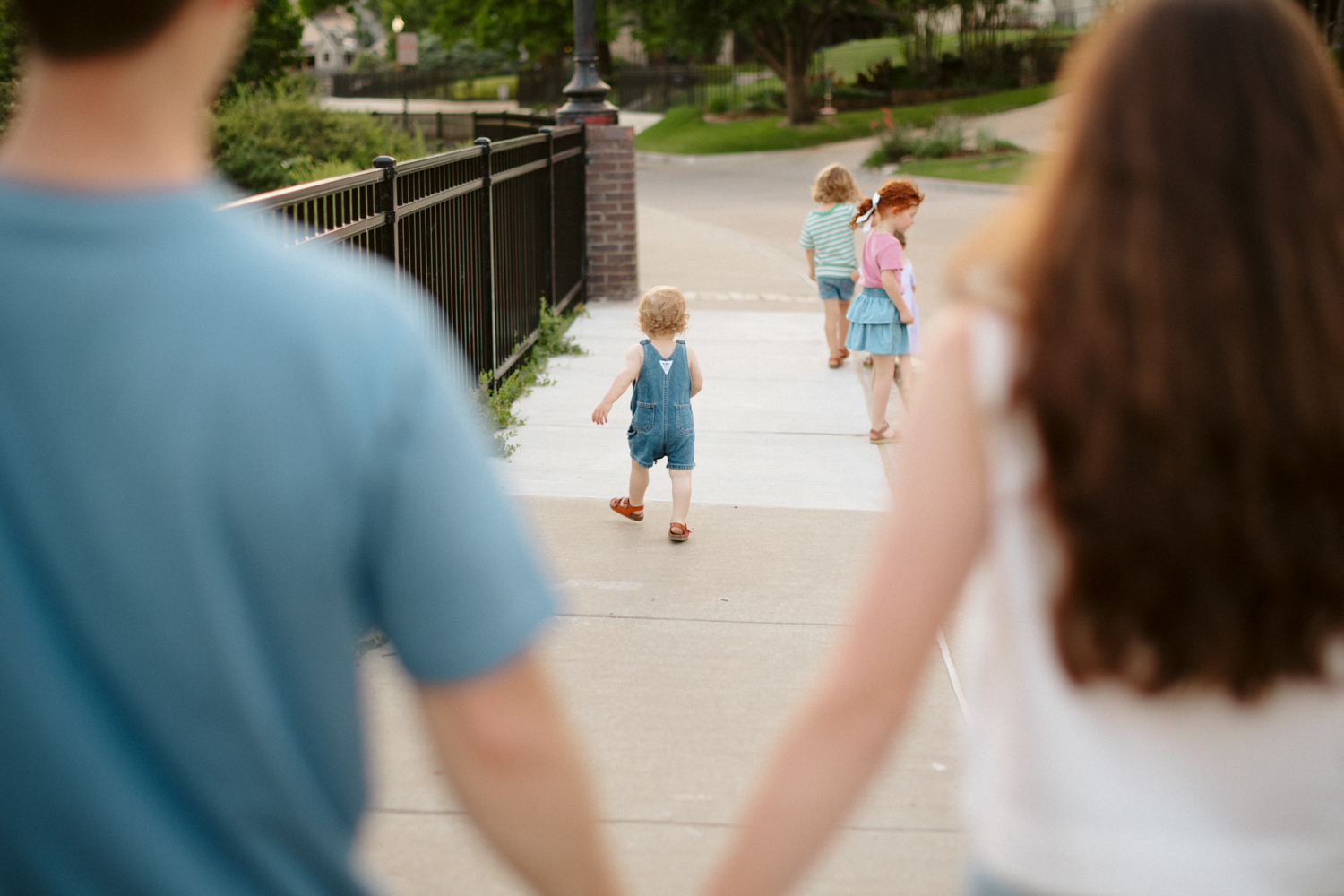 young family walking during a family photo session in Oklahoma City