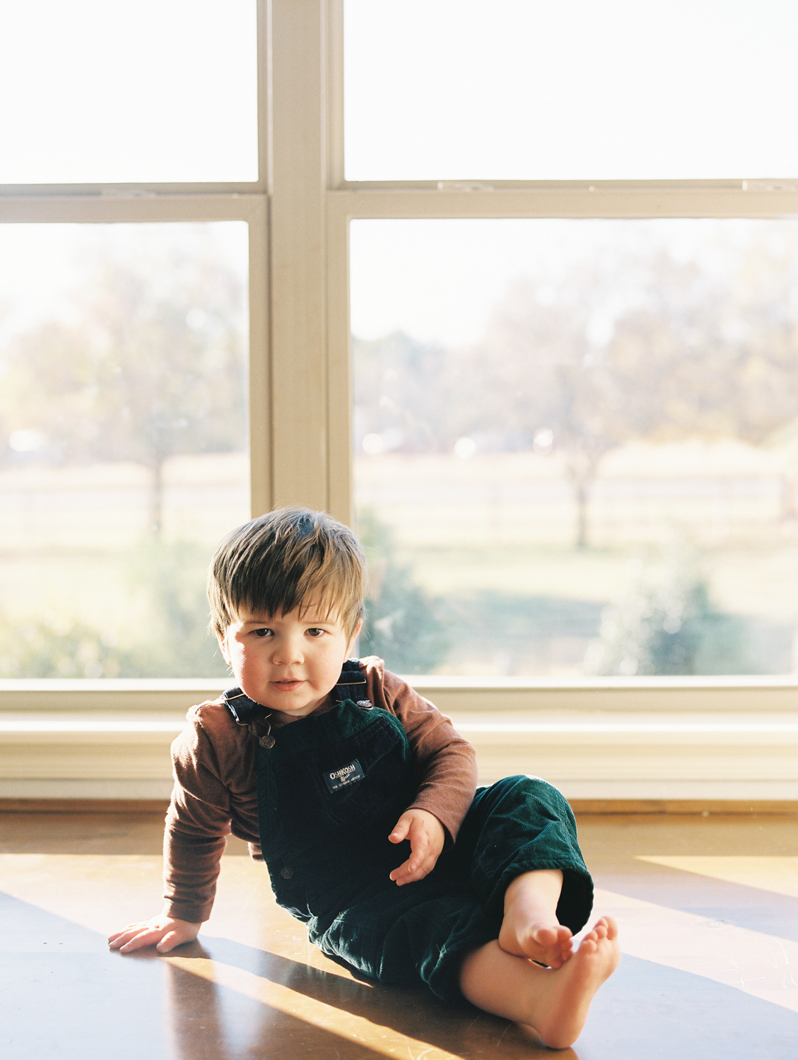 A portrait of a toddler during a natural light lifestyle session in Nichols Hills, OK.