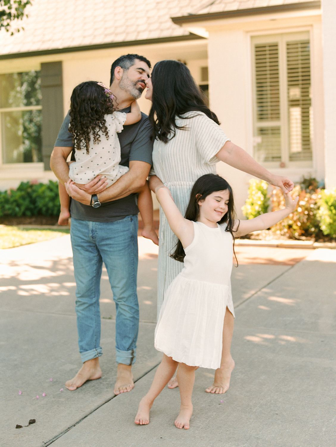 family of 4 playing in their front yard in oklahoma city
