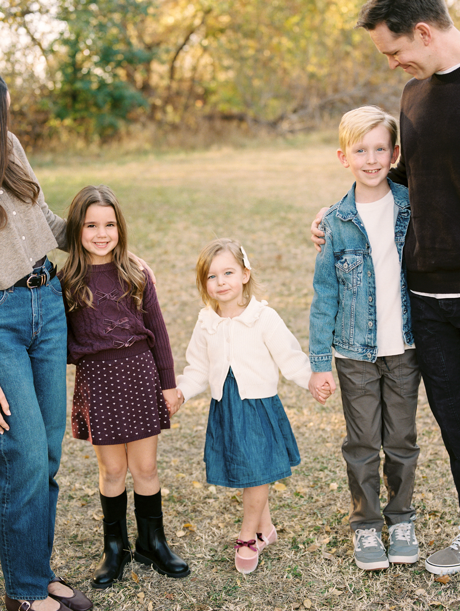 portrait of three children tucked between their parents
