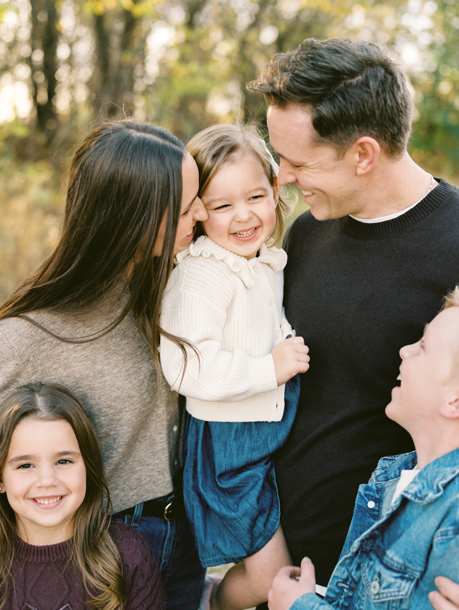 close up of an okc family snuggling and laughing together