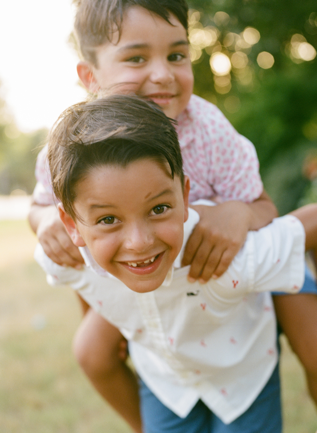 older brother giving younger brother a piggy back ride