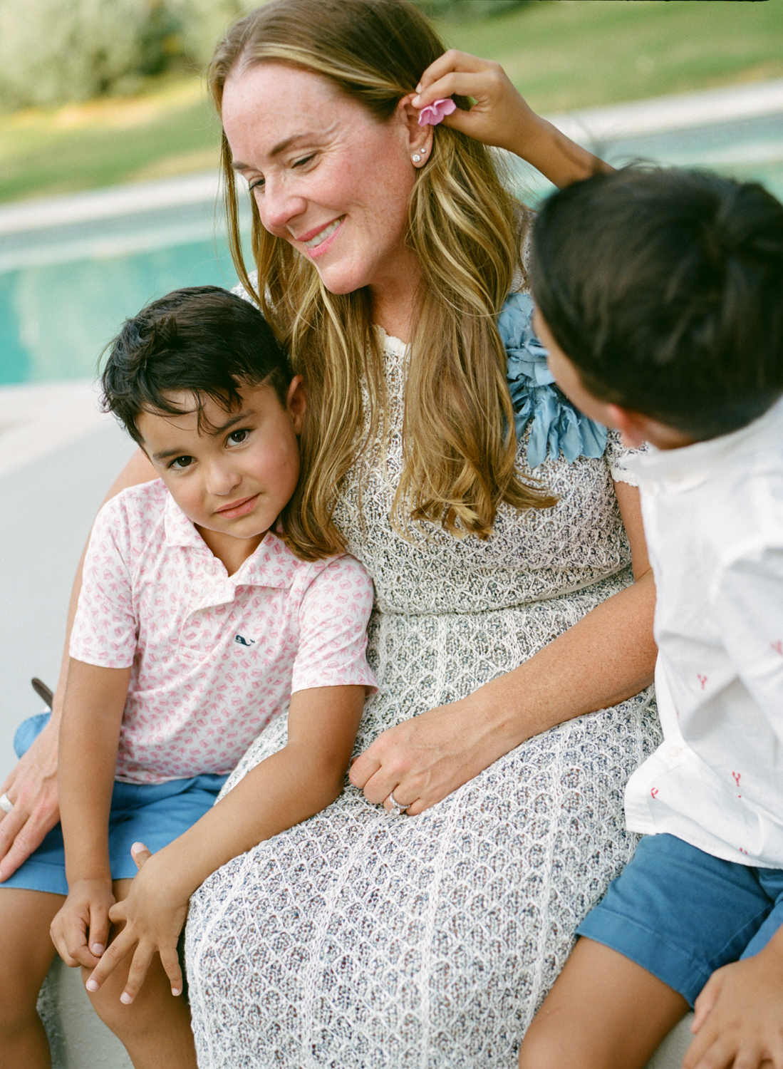 son putting flower in mom's hair