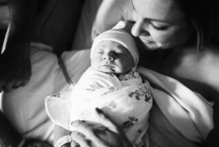 mother holding newborn baby in hospital