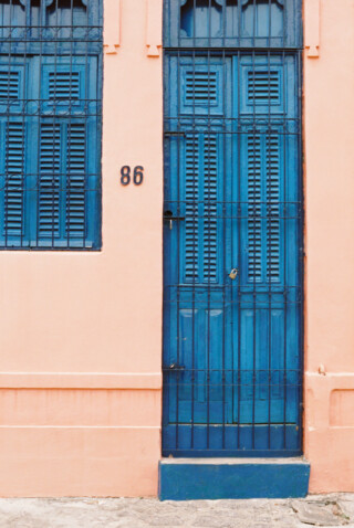 blue door on pink building