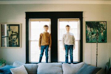 brothers standing in window